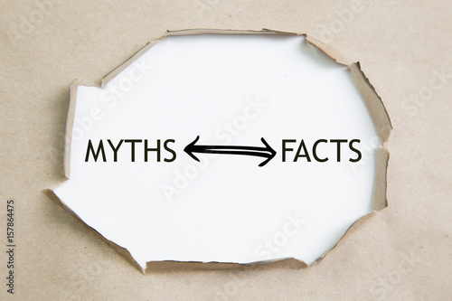 The text Facts vs myths appearing behind torn brown paper