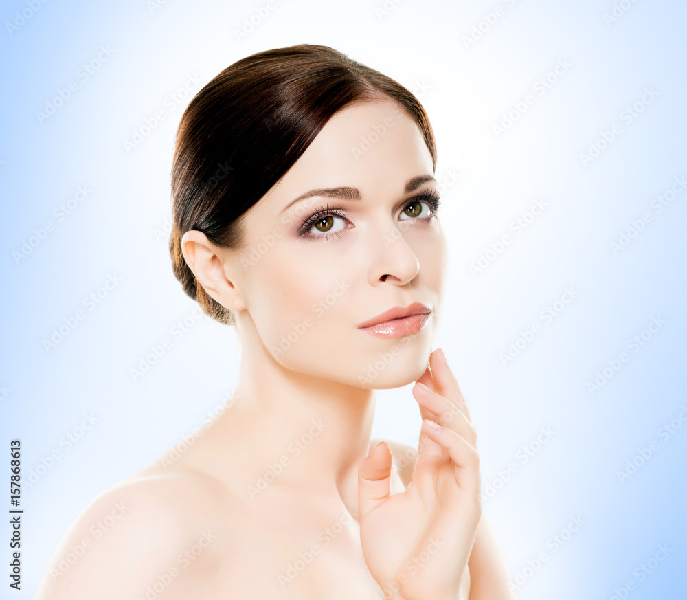 Portrait of young, beautiful and healthy woman: over blue background. Healthcare, spa, makeup and face lifting concept. Portrait of young, beautiful and healthy woman: over blue background. Healthcare, spa, makeup and face lifting concept.