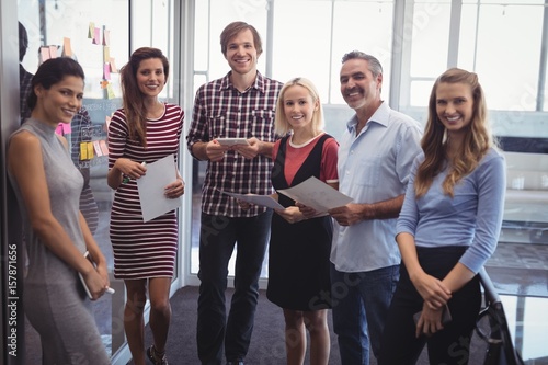 Confident business people standing in creative office
