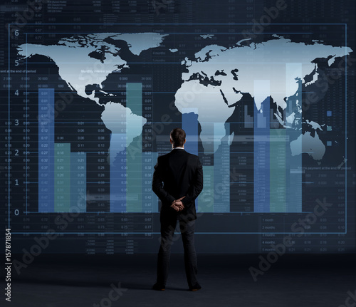 Businessman standing over diagram. World map background. Business, globalization, worldwide concept.