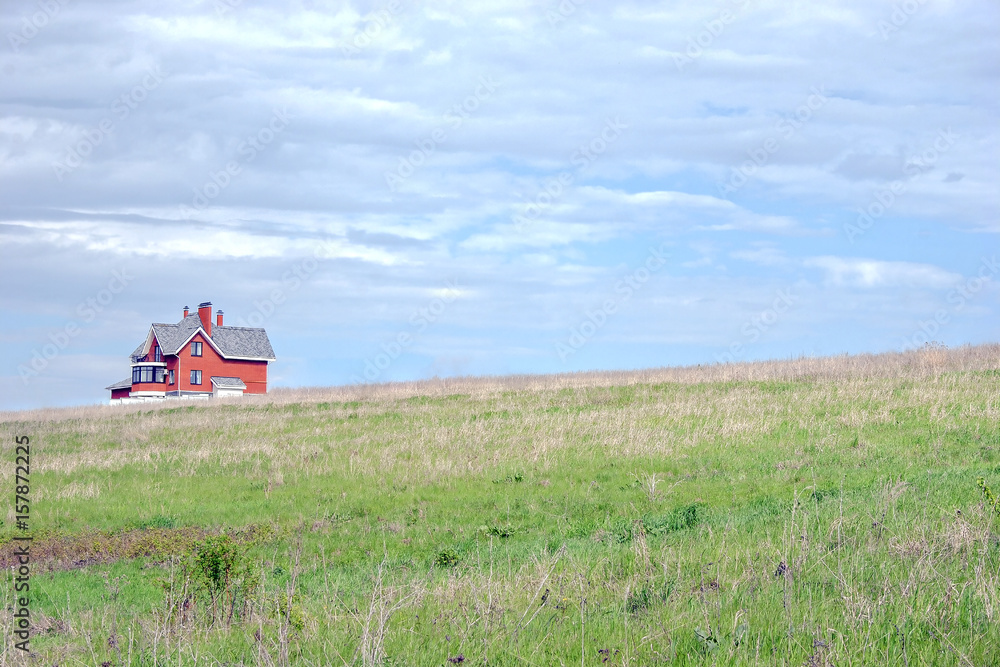 Fototapeta premium house on a background of blue sky with clouds