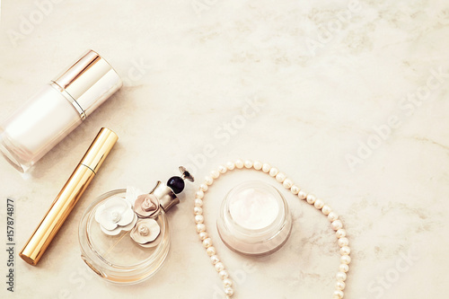 Beauty products top view on white marble background. Copy space