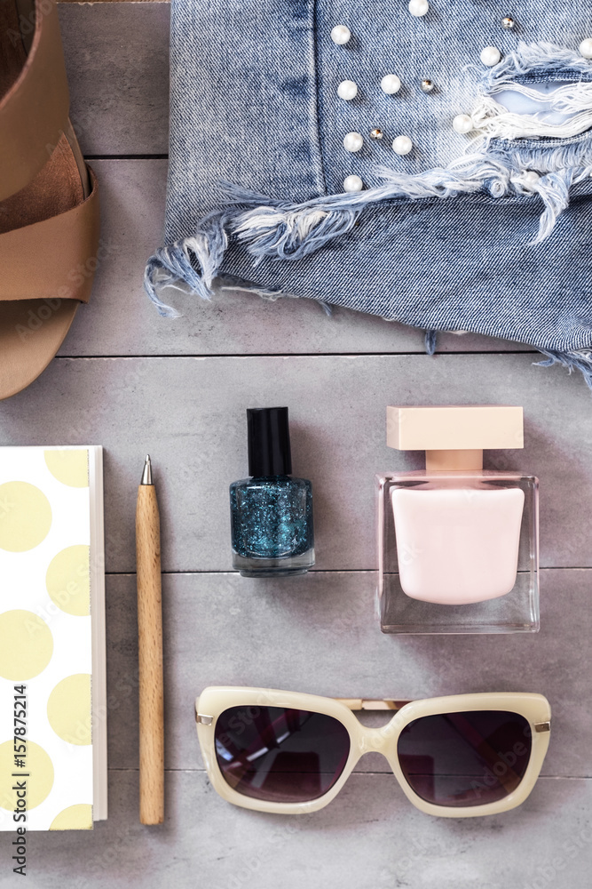 Arranged woman fashion and beauty accessories flat lay on concrete background. Top view. Blogging concept Arranged woman fashion and beauty accessories flat lay on concrete background. Top view. Blogging concept