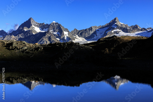 View of OberGabelhorn and Zinalrothorn reflected in the blue waters Zermatt Canton of Valais Switzerland Europe