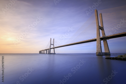 The colors of dawn on Vasco da Gama Bridge that spans the Tagus River in Parque das Nações Lisbon Portugal Europe