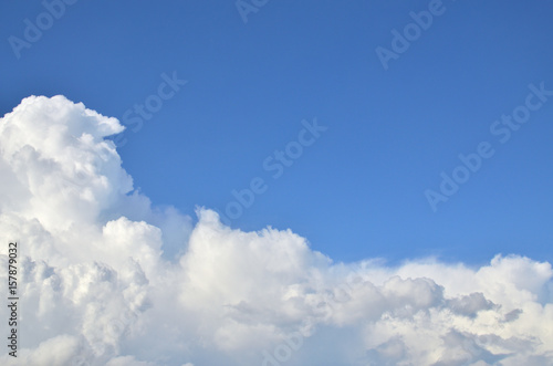 Blue sky and white fluffy clouds with a space for text