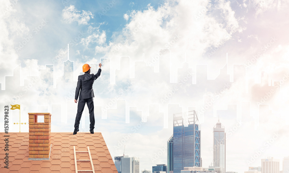 Man architect draw silhouette of modern city on blue sky. Mixed Man architect draw silhouette of modern city on blue sky. Mixed