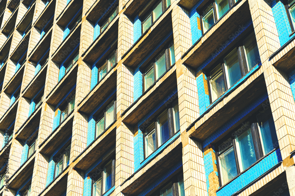 Residential cells of the hostel building. Facade of the building with many windows. Perspective view down. Architectural background