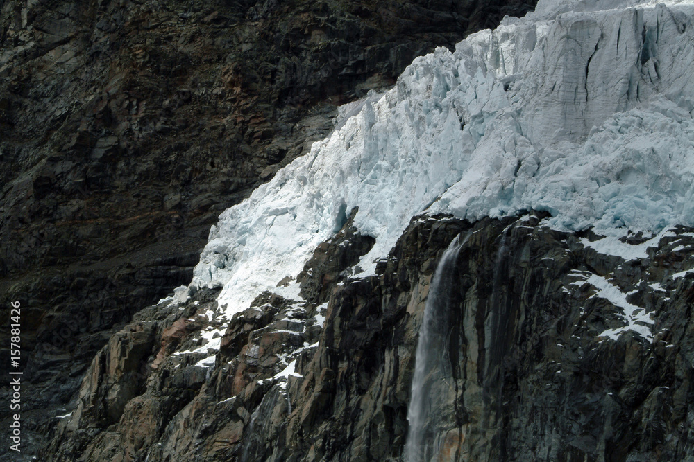 A waterfall collects the meltwater from the Fellaria glacier. Valmalenco. Valtellina Lombardy. Italy Europe A waterfall collects the meltwater from the Fellaria glacier. Valmalenco. Valtellina Lombardy. Italy Europe