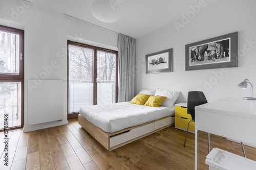 White bedroom with bed and desk