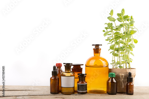 Vintage pharmacy bottles and medical herb isolated on white