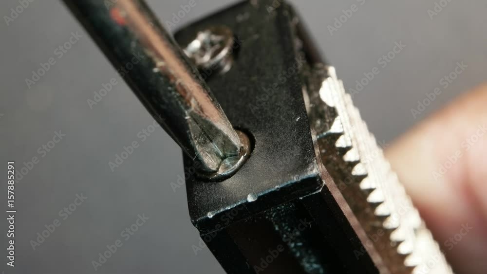 Close up of a screwdriver screwing a bolt
Close up of a screwdriver screwing a bolt
