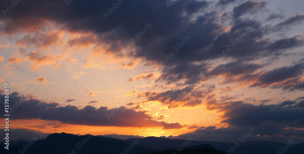 Sunset. Sky clouds background. Ridge Mountains silhouette. Skyline. Montenegro