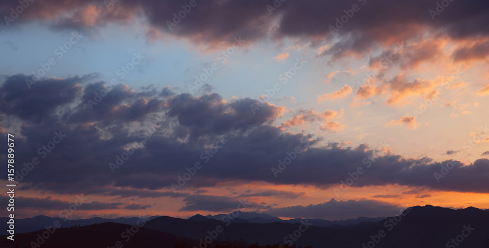 Sunset. Sky clouds background. Ridge Mountains silhouette. Skyline. Montenegro