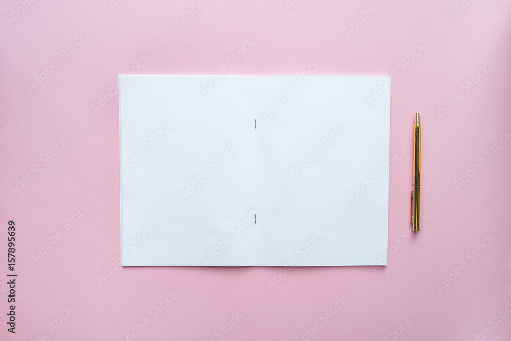 White empty notebook on pink background White empty notebook on pink background