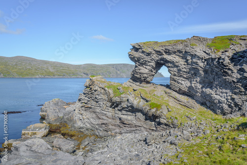 Cliff formation Kirkeporten with view to the North Cape Horn, Finnmark, Norway photo