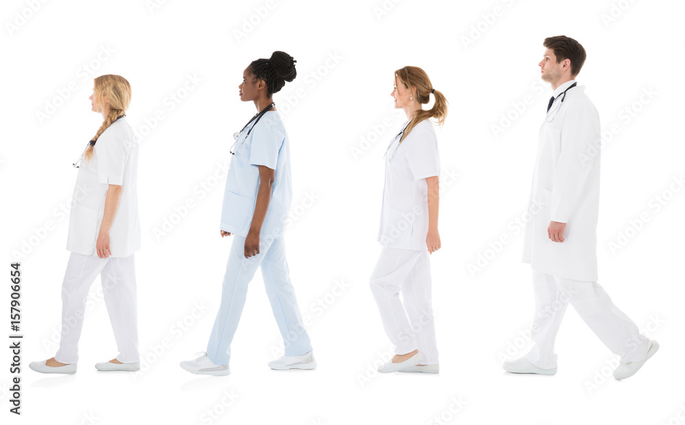 Multiracial Medical Team Walking In Row