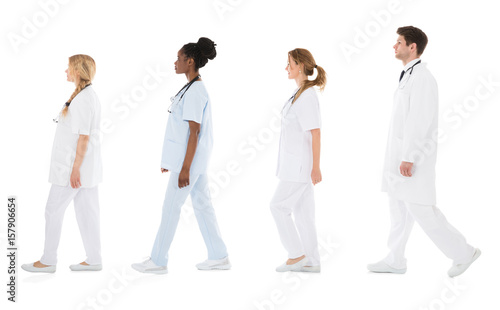 Multiracial Medical Team Walking In Row