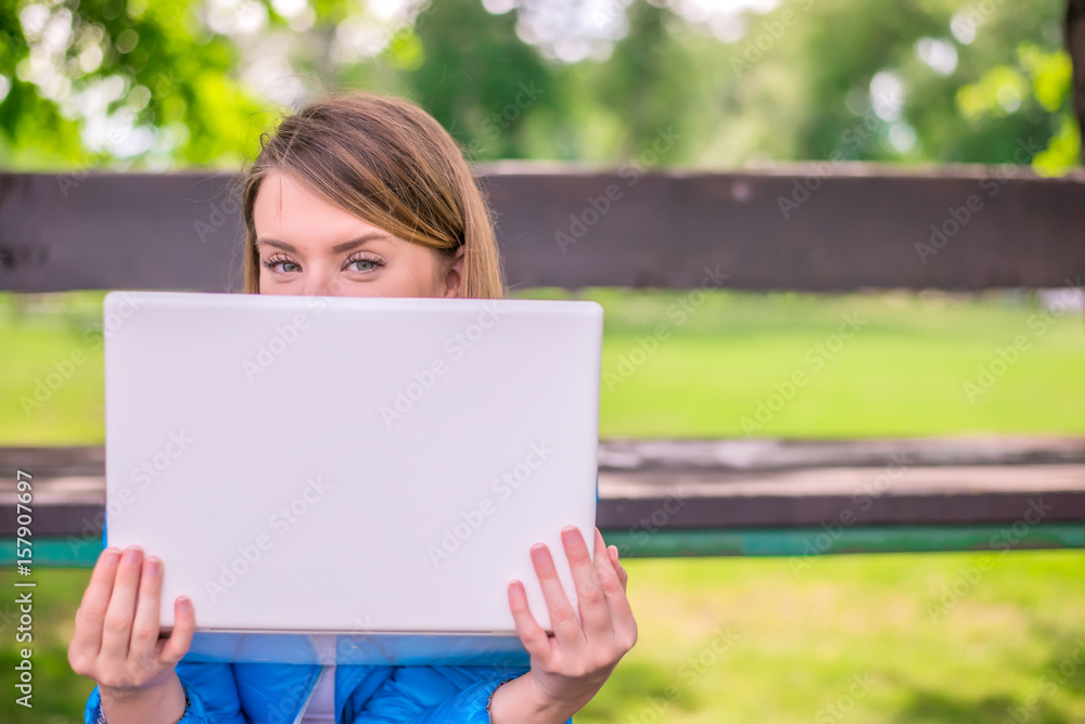 omputer and fresh air. Woman hiding face behind laptop monitor omputer and fresh air. Woman hiding face behind laptop monitor