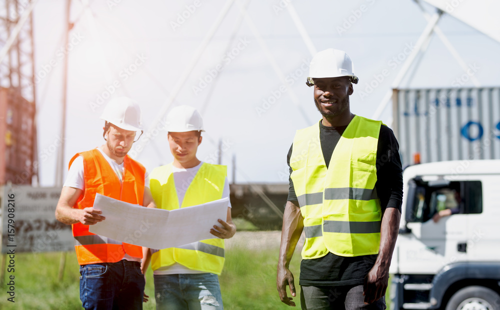Three men on a construction site Three men on a construction site