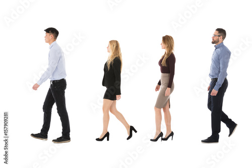 Male And Female College Students Walking In Row