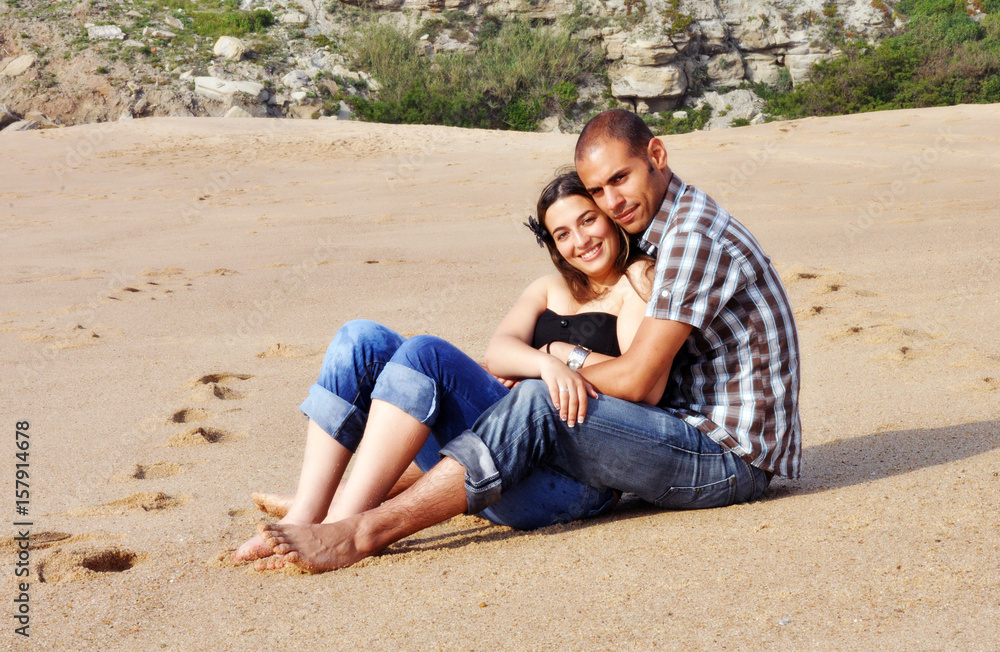 Fototapeta premium Young happy couple dating and teasing on the beach