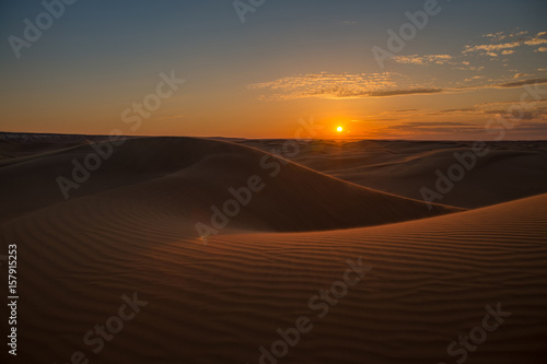Beautiful sunset in sand dunes over barkhan desert in Kazakhstan