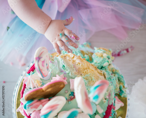 Baby eating cake, dirty hands