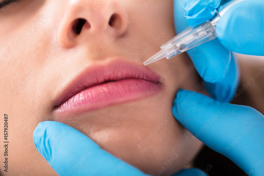 Cosmetologist Applying Permanent Make Up On Lips Cosmetologist Applying Permanent Make Up On Lips