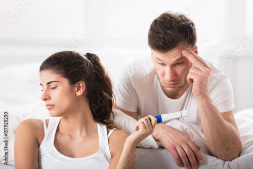 Sad Woman Showing Her Husband Positive Pregnancy-test