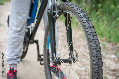 Relax on a mountain bike ride along the forest path. Sports and the concept of active life in the summer. Horizontal frame