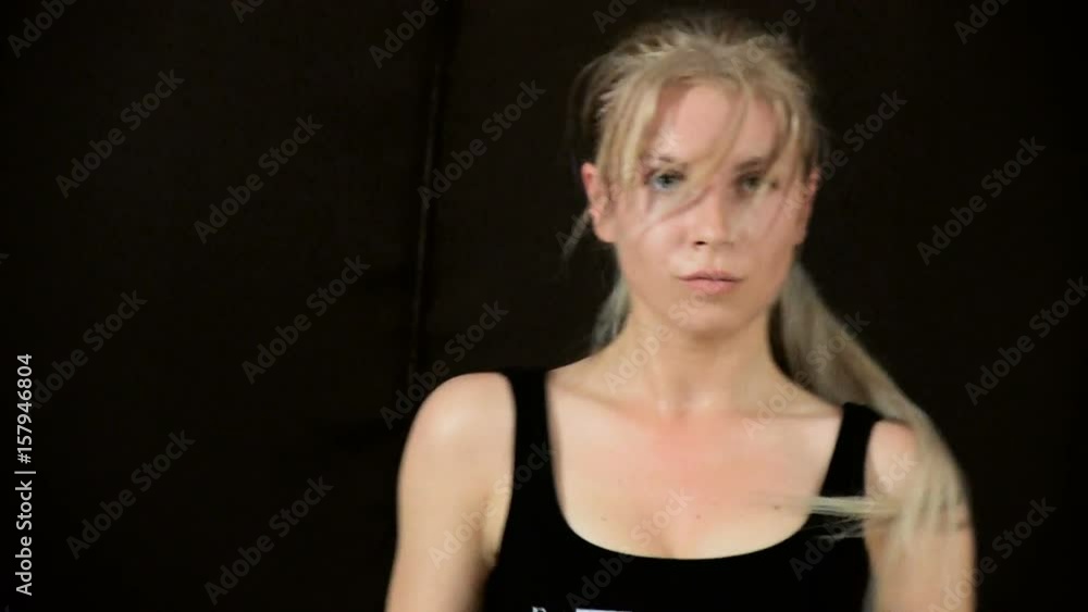 A blonde girl women with very long hair dances go-go. Trains. Wet with sweat. Spotted. Close-up. Separate movements. Slow motion. Pobrennye in the tail of hair. On a black background. A blonde girl women with very long hair dances go-go. Trains. Wet with sweat. Spotted. Close-up. Separate movements. Slow motion. Pobrennye in the tail of hair. On a black background.
