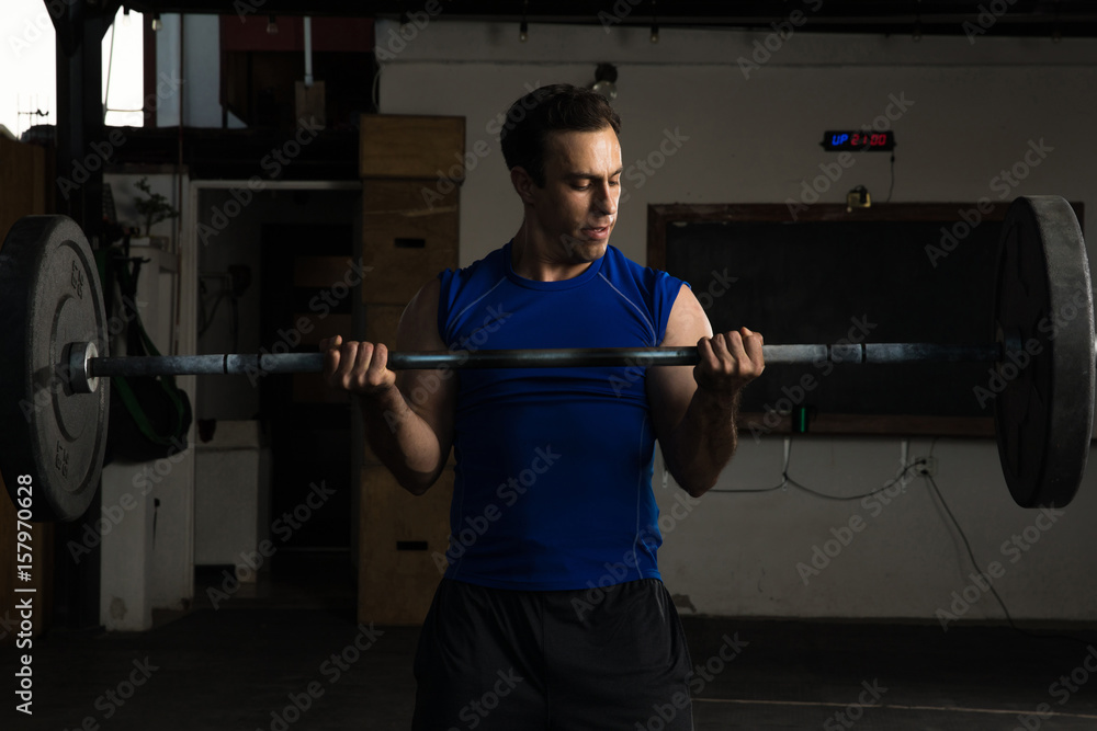 Hispanic man lifting a barbell Hispanic man lifting a barbell