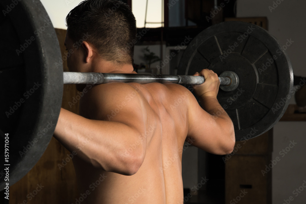 Strong man doing a barbell squat Strong man doing a barbell squat