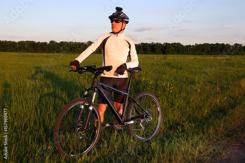 cyclist with a bike in the sun.