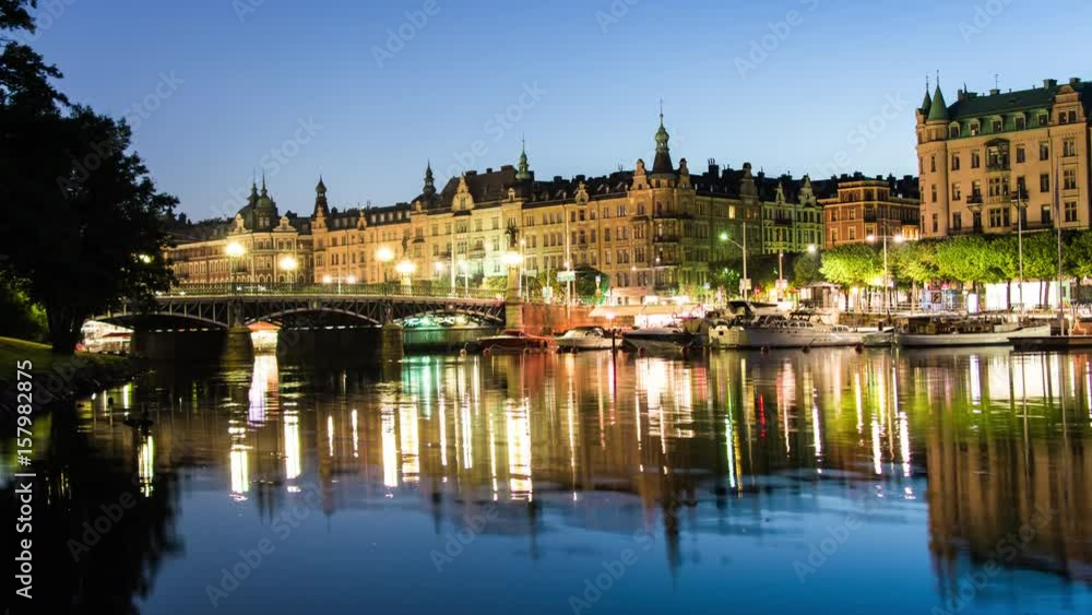 Bridge in central Stockholm at night 4K Time Lapse Tilt. City river, buildings, reflections in the water Bridge in central Stockholm at night 4K Time Lapse Tilt. City river, buildings, reflections in the water