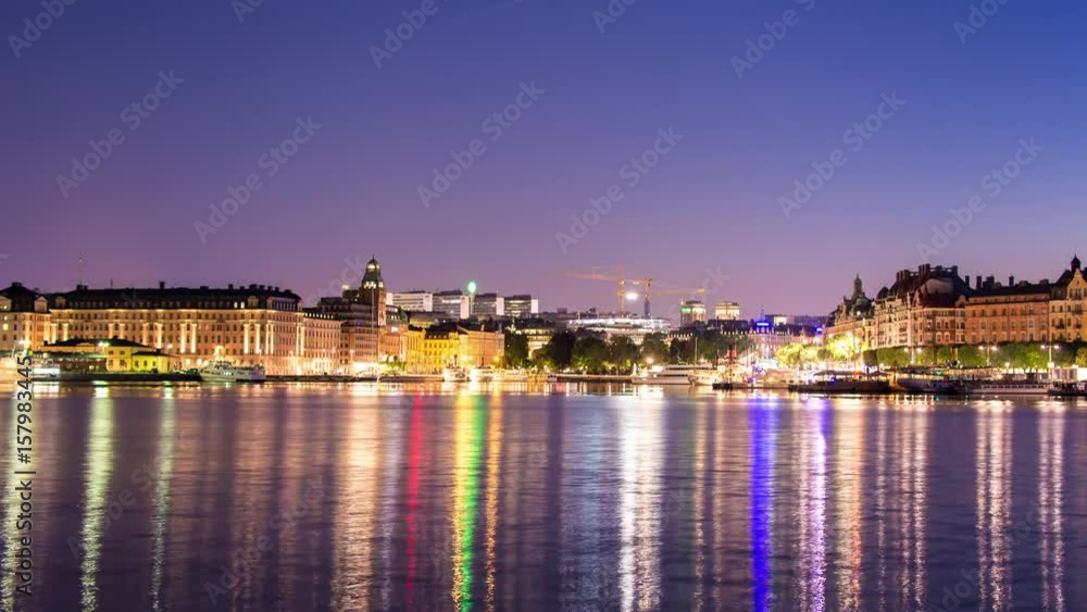 City buildings by the water in Stockholm, Sweden 4K Time Lapse. Cityscape skyline at night, reflections in the water City buildings by the water in Stockholm, Sweden 4K Time Lapse. Cityscape skyline at night, reflections in the water