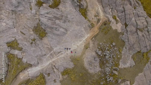 Aerial shot zooming out over hikers, Mount Champaqui, Cordoba Province, Argentina photo