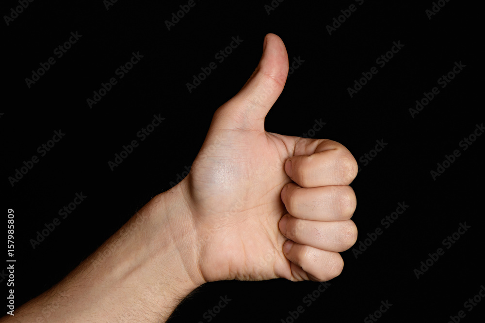 Showing a thumb up gesture. Isolated on black background. Like.