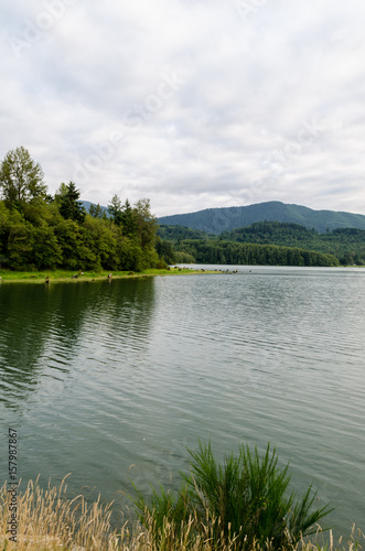 View of a Calm Lake with a Mountain in the Background on a Cloud Day