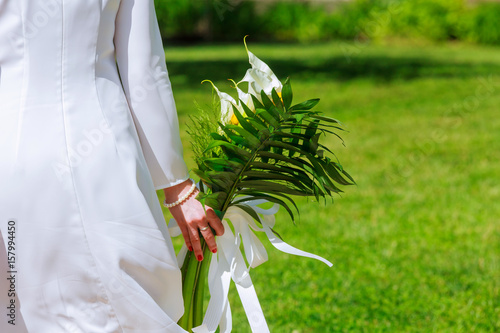 Close-up view of a bride holding a bouquet white flowers photo