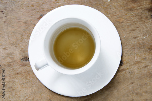 Empty cup of coffee with coffee stained on wooden table