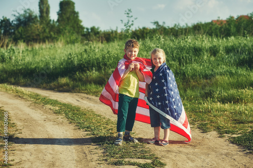a truly Patriotic children with USA flag . The concept of independence day