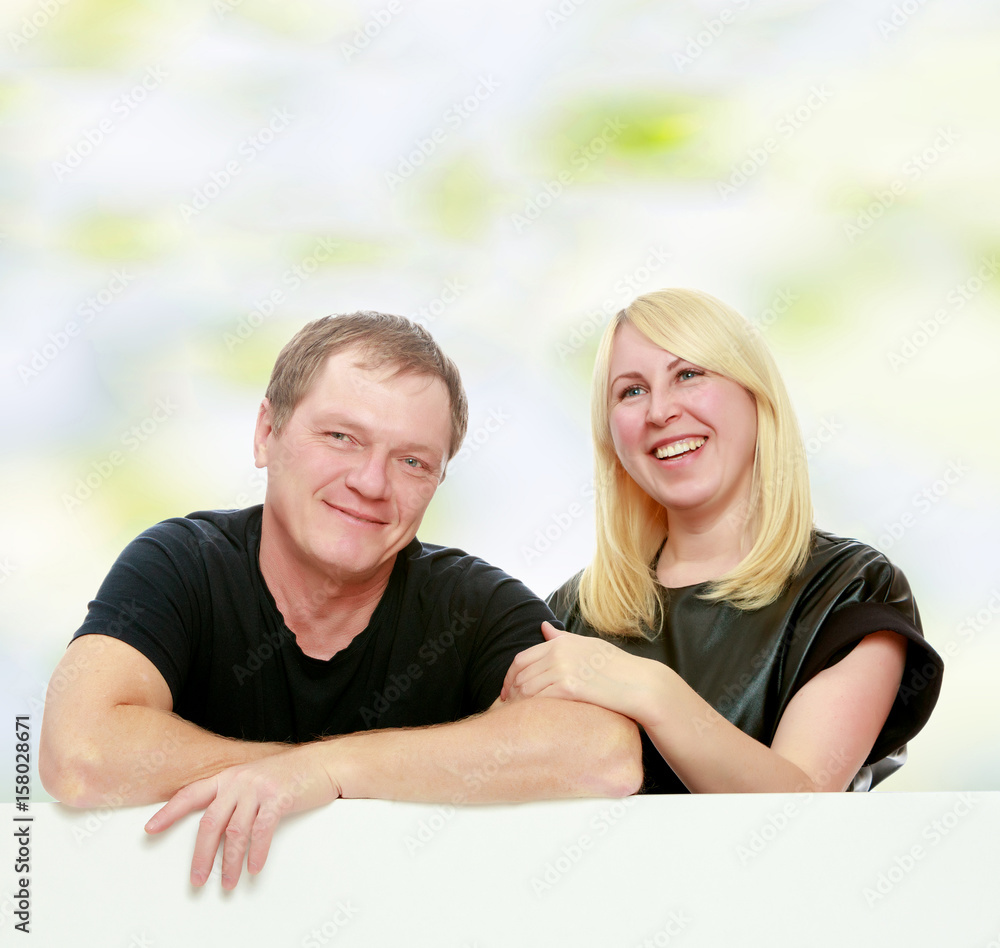Fototapeta premium Happy family at the white banner.