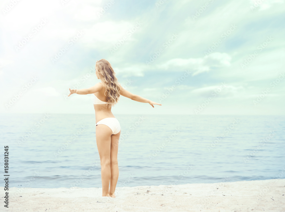 Attractive, fit girl in white bikini posing on the beach. Traveling, vacation, holiday, concept. Attractive, fit girl in white bikini posing on the beach. Traveling, vacation, holiday, concept.