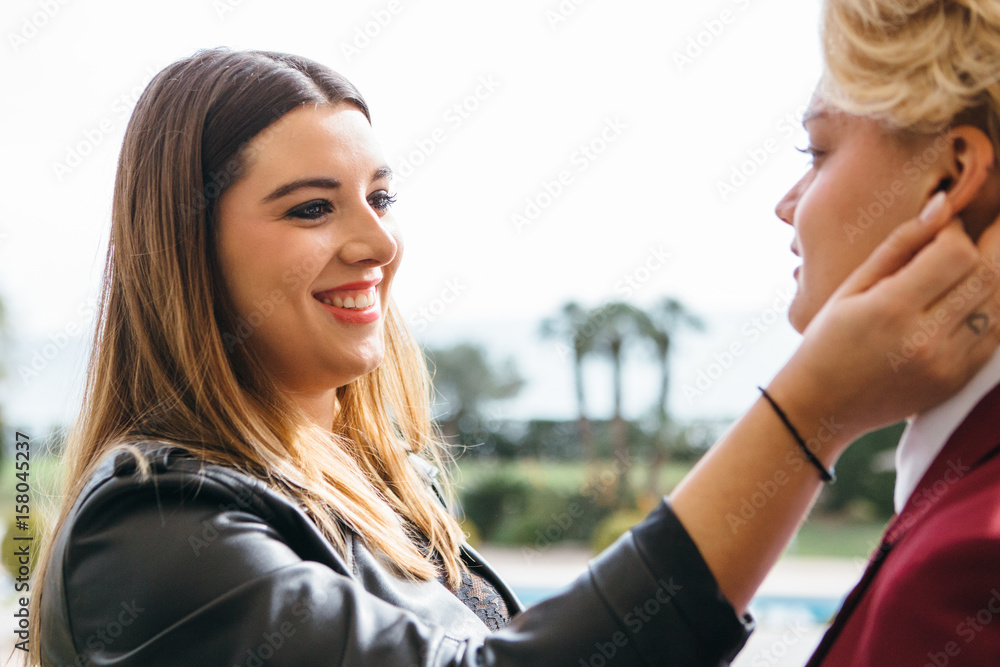 Smiling woman stroking girlfriends Smiling woman stroking girlfriends