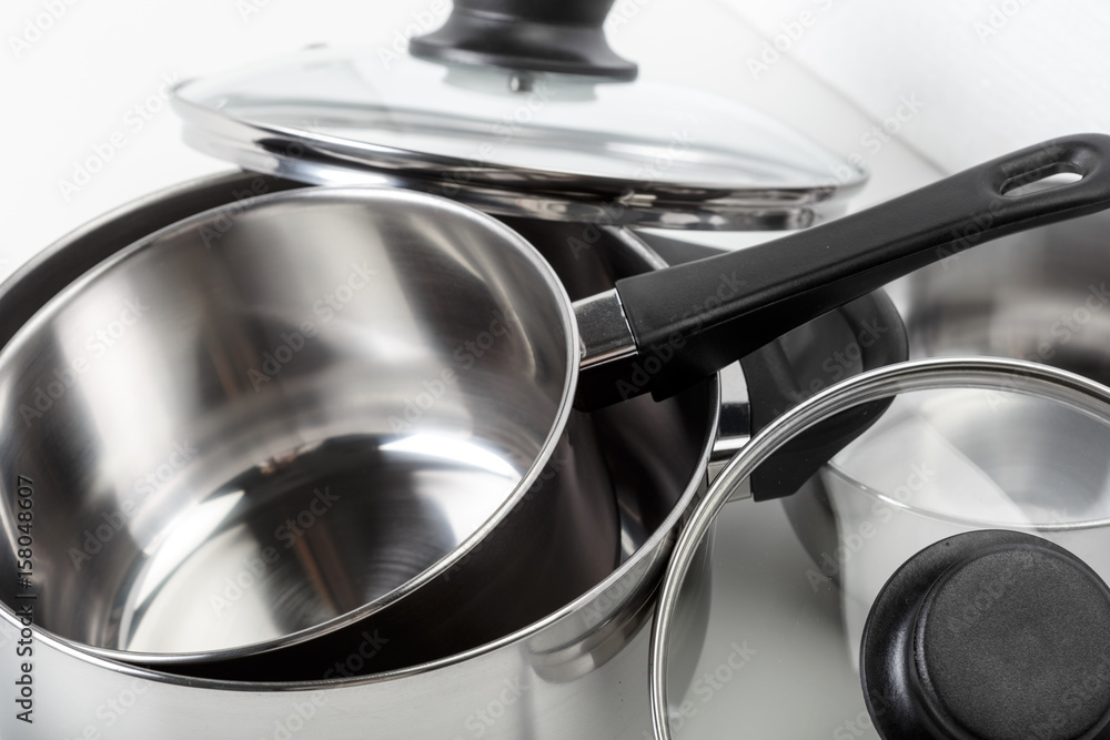 Stainless steel pots and pans isolated on white Stainless steel pots and pans isolated on white