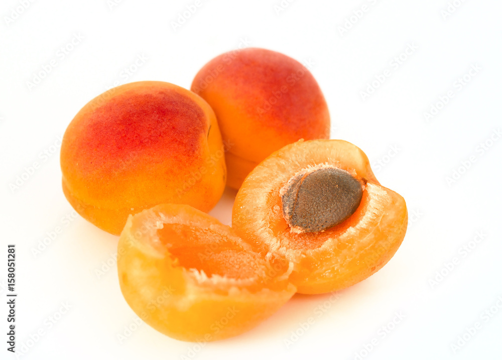 Ripe apricots with seed solated on white background. Healthy fruit eating.