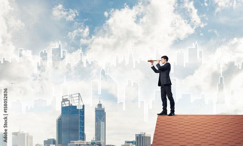 Engineer man standing on roof and looking in spyglass. Mixed med Engineer man standing on roof and looking in spyglass. Mixed med