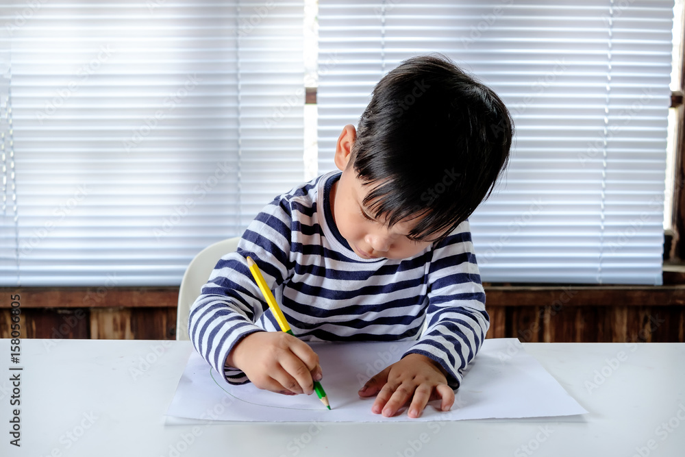 Asian Little child drawing on the paper Asian Little child drawing on the paper